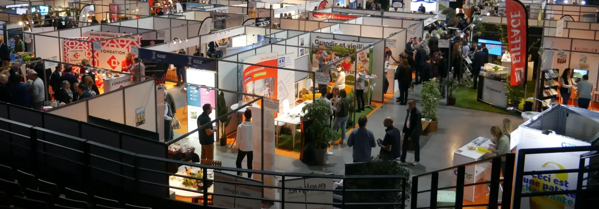 Vue d’ensemble des stands d’un salon des Maires, des Communes et des Intercommunalités